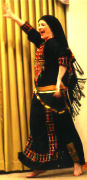Photo of Chelydra in Persian bandari caftan and pants.